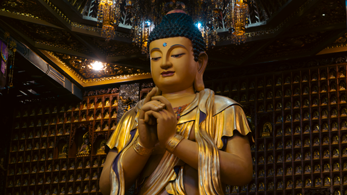 Free Beautiful golden Buddha statue inside a richly decorated temple, showcasing serenity and craftsmanship. Stock Photo
