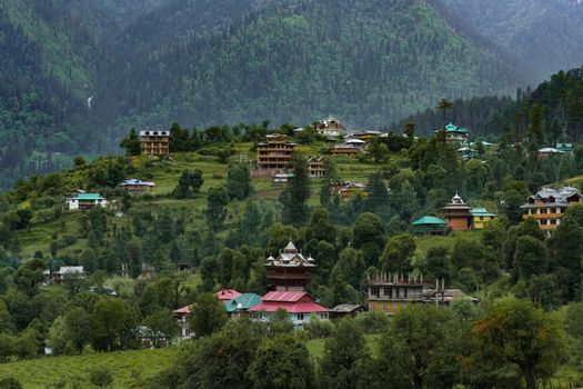 Picturesque village in Shangarh, Himachal Pradesh, nestled in lush green Himalayan landscapes.