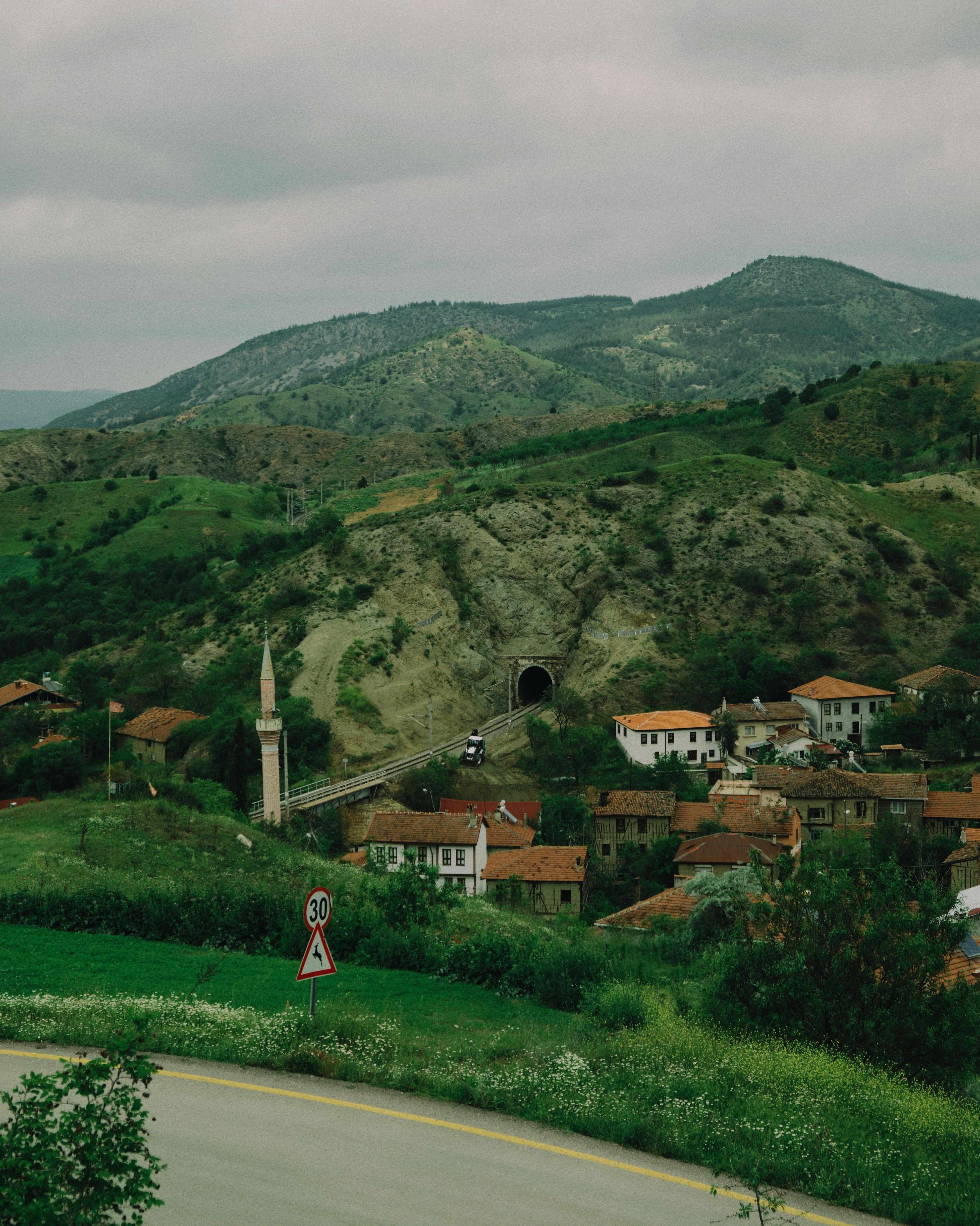 Picturesque village of Bekdemir, Bilecik with green hills and a tunnel view.