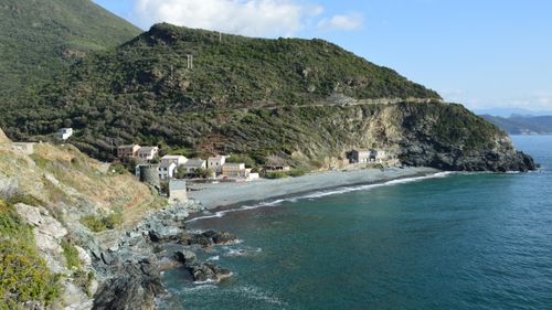 Free Beautiful coastal landscape of Olmeta-di-Capocorso in Corsica, featuring rugged cliffs and clear blue waters. Stock Photo