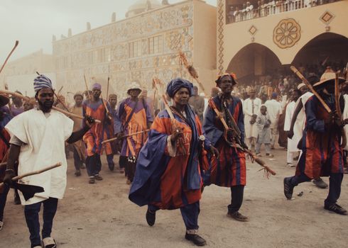 Cultural parade with participants in colorful traditional attire during a festival.