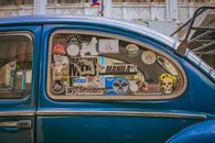 Close-up of a vintage car window adorned with various stickers in Manila, Philippines.