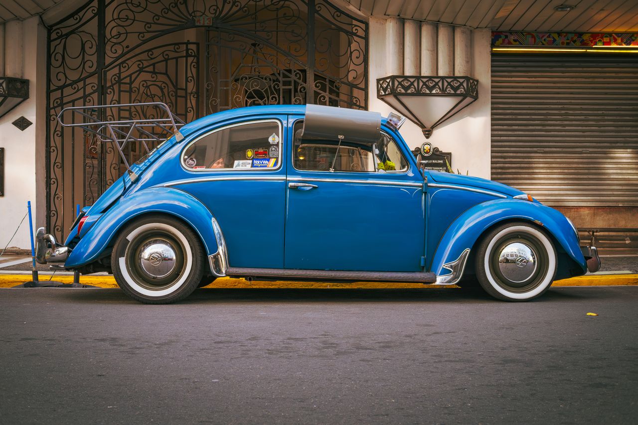 classic blue volkswagen beetle parked on a street in manila showcasing