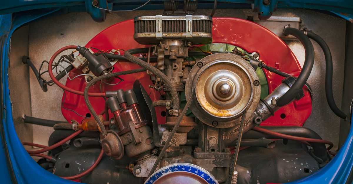 Detailed view of a vintage car engine, showcasing mechanical components and colorful housing.