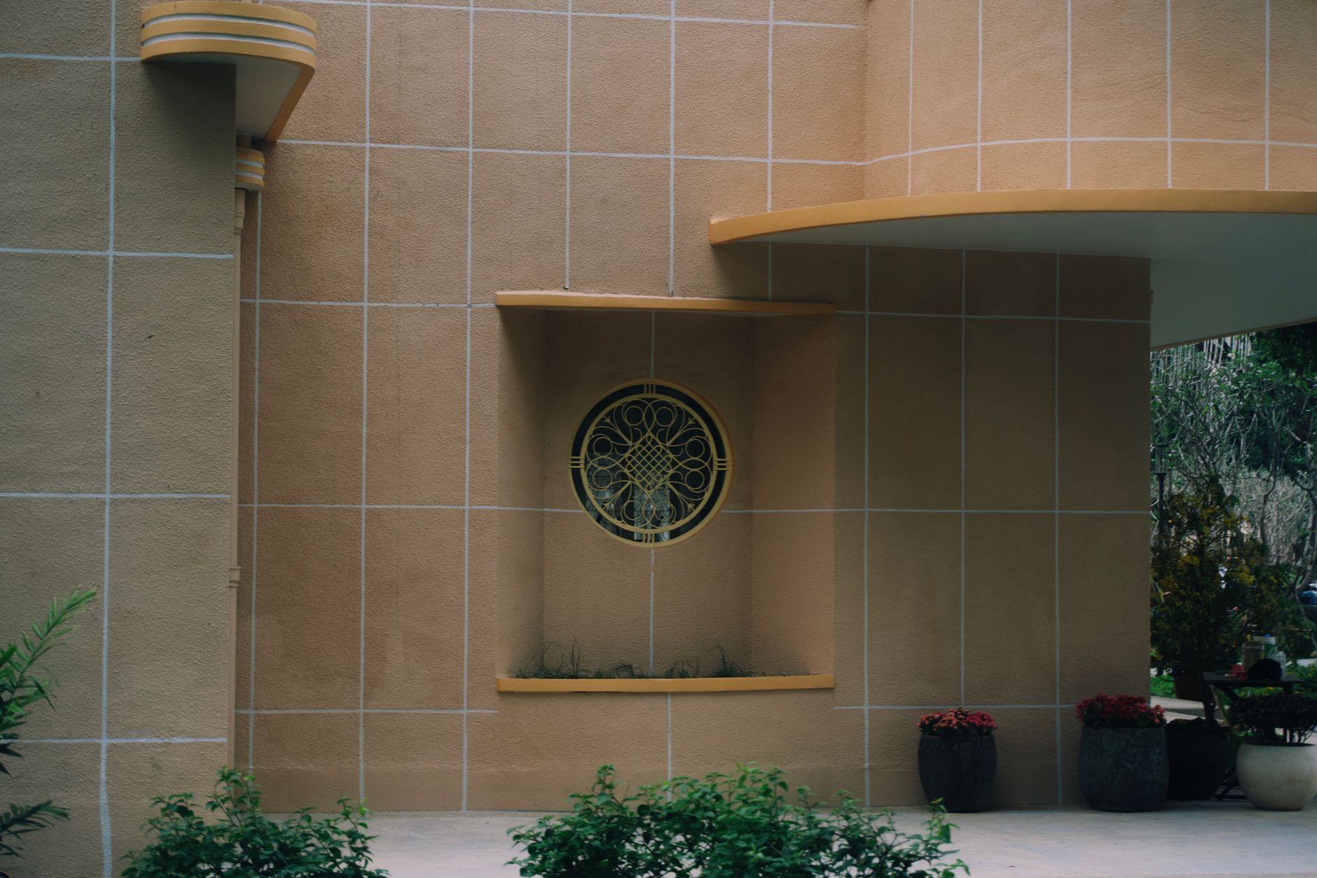 Close-up of Art Deco architecture showcasing a geometric circular window and elegant wall patterns.. close, deco, architectur
