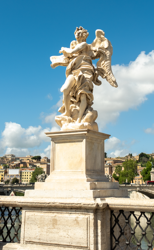Free Baroque angel statue on a bridge in Rome, vibrant summer day. Stock Photo