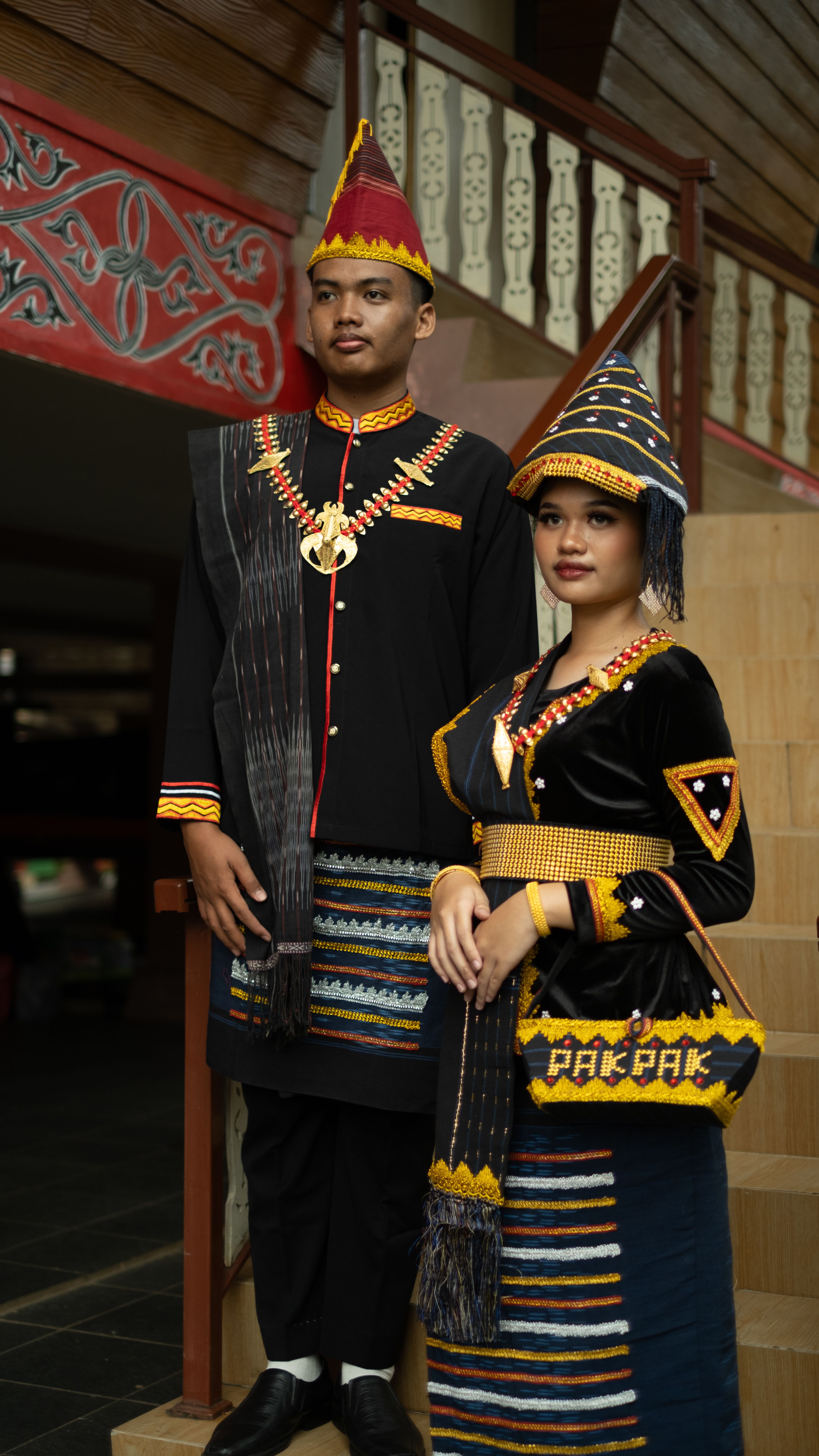 Couple in traditional Indonesian wedding attire, showcasing cultural heritage.