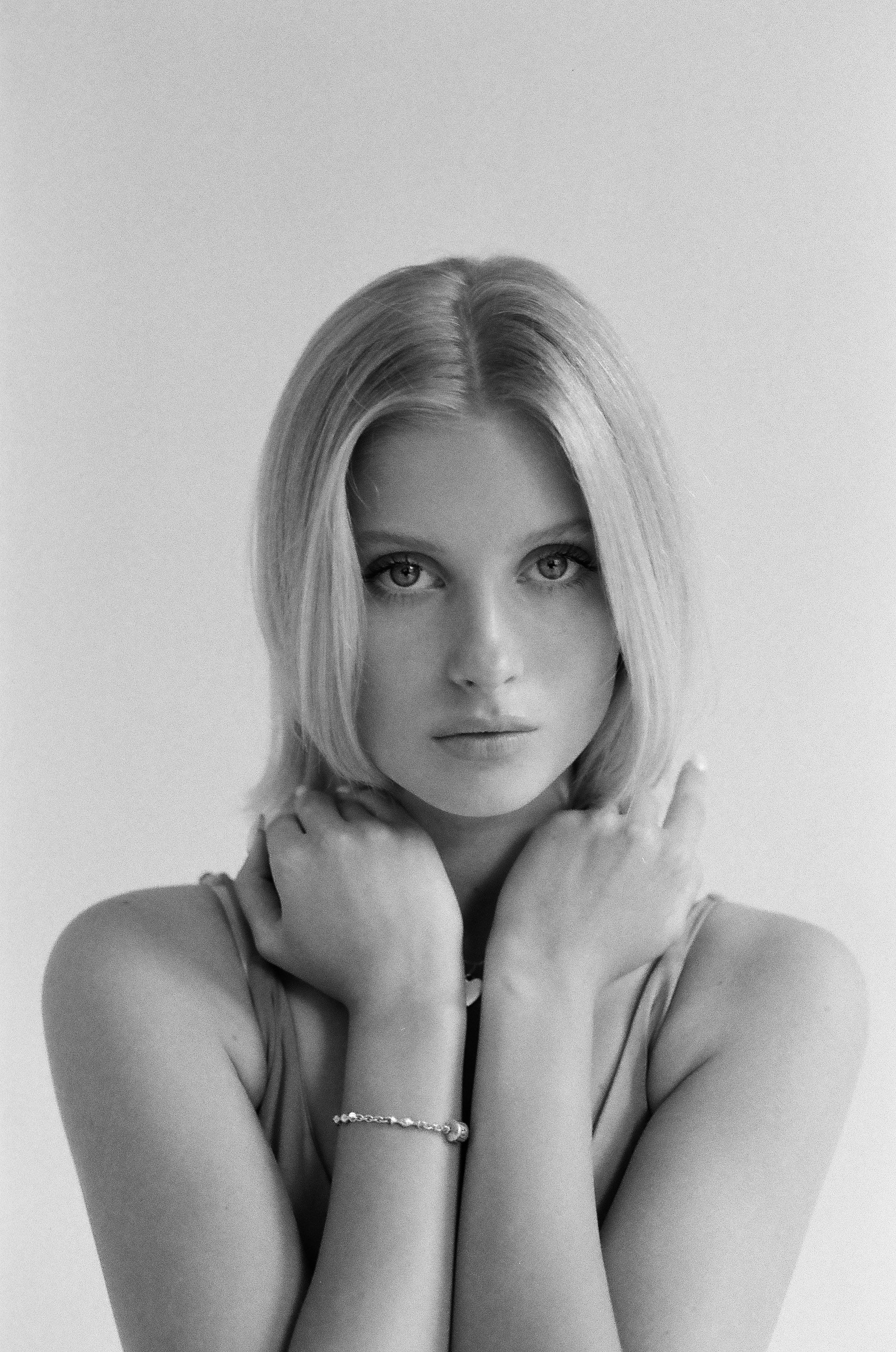 Timeless black and white portrait of a young woman with a serene expression.