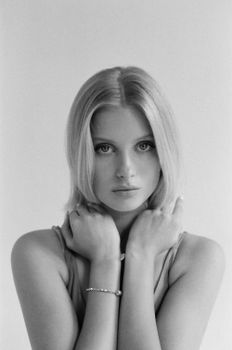 Timeless black and white portrait of a young woman with a serene expression.