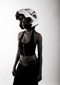 Monochrome portrait of a woman wearing a fashionable outfit and a helmet.