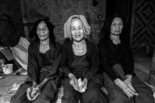 Black and white portrait of three elderly women in traditional clothing, Indonesia.