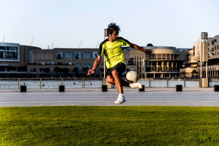 Man In Green Shirt Playing Soccer