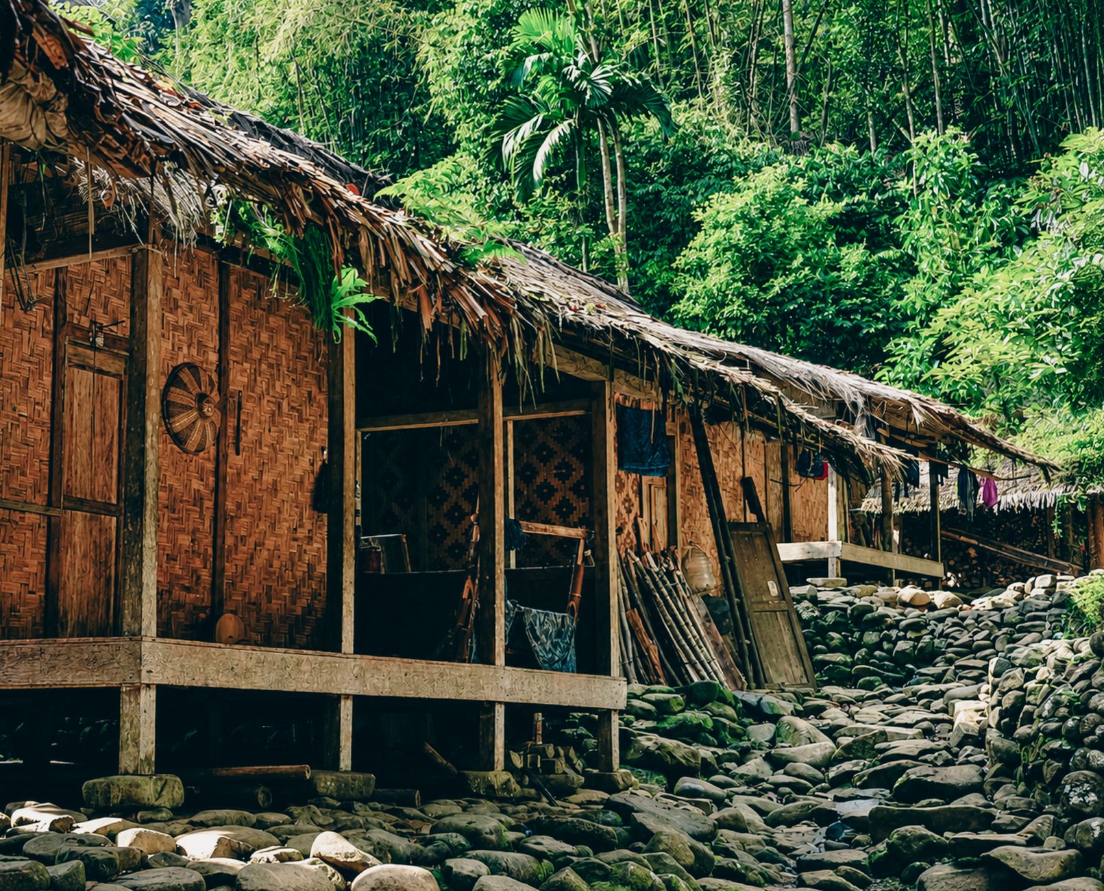 Charming bamboo houses with thatched roofs nestled in lush greenery in Banten, Indonesia.