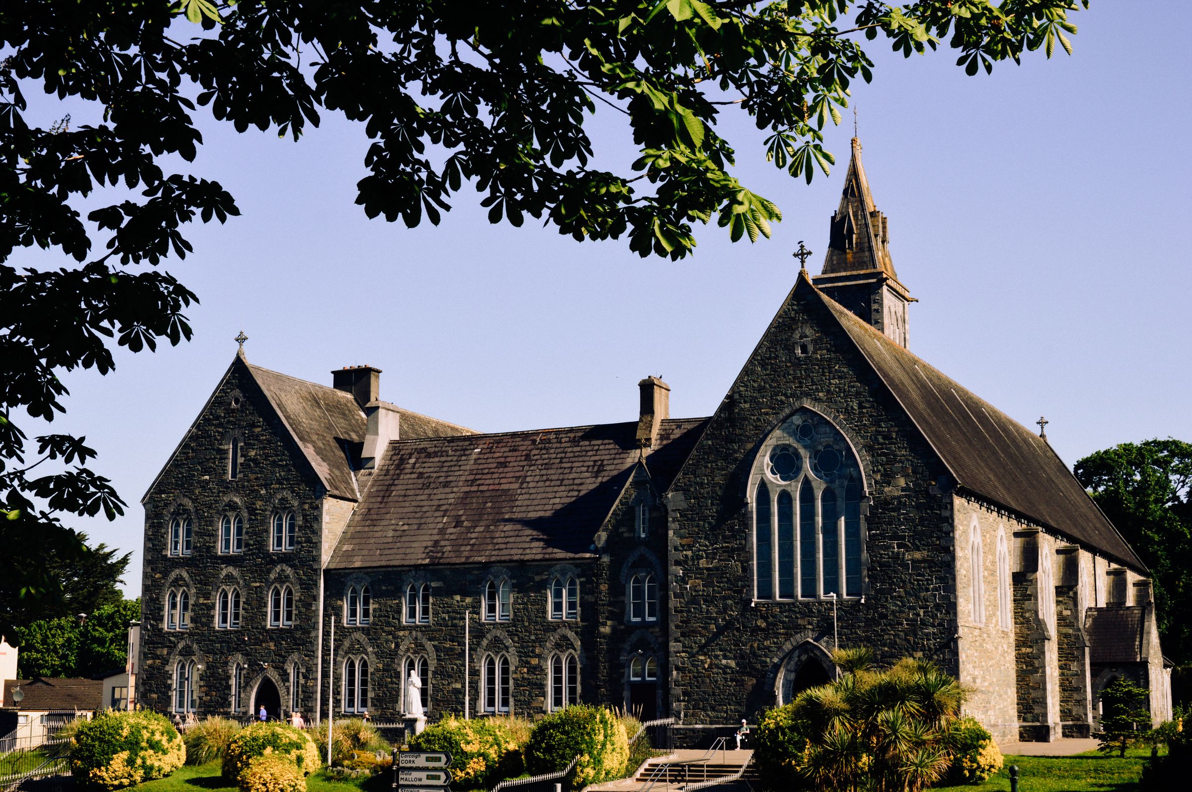 Stone church in Killarney, Ireland, under clear blue skies