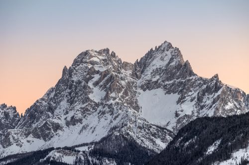 Free Breathtaking view of the Dolomites' snow-covered peaks during sunset, capturing their rugged beauty and serene atmosphere. Stock Photo
