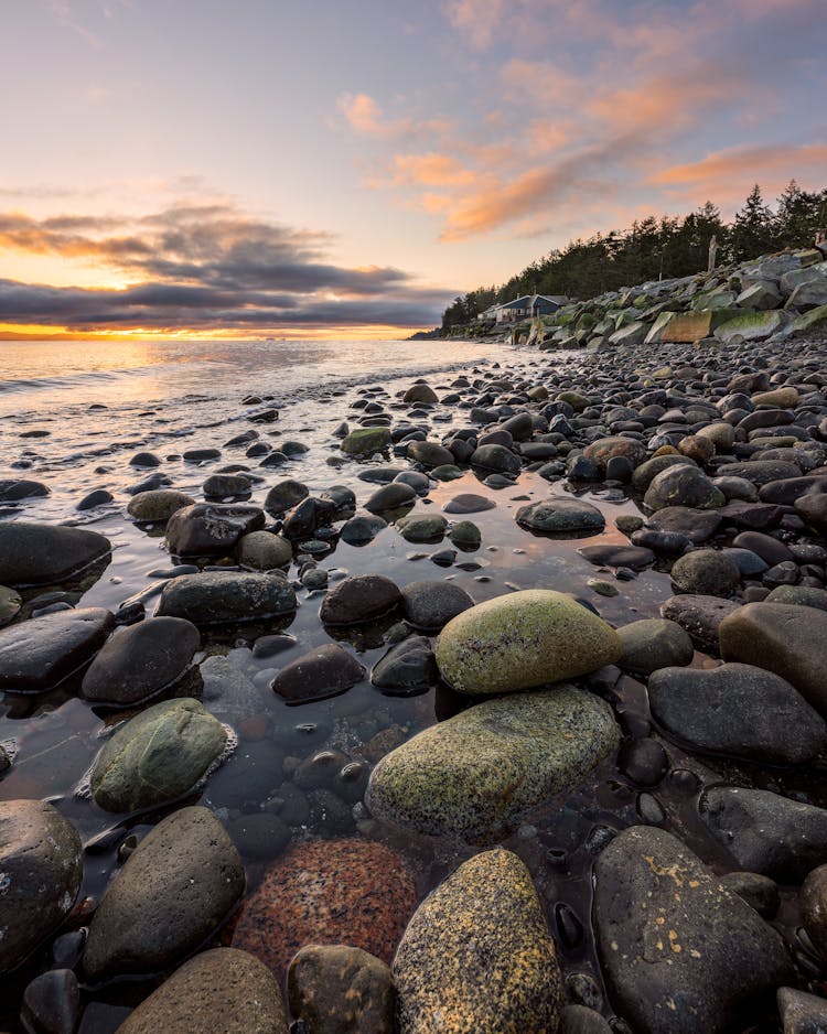 Photo Of Rocky Seashore During Golden Hour