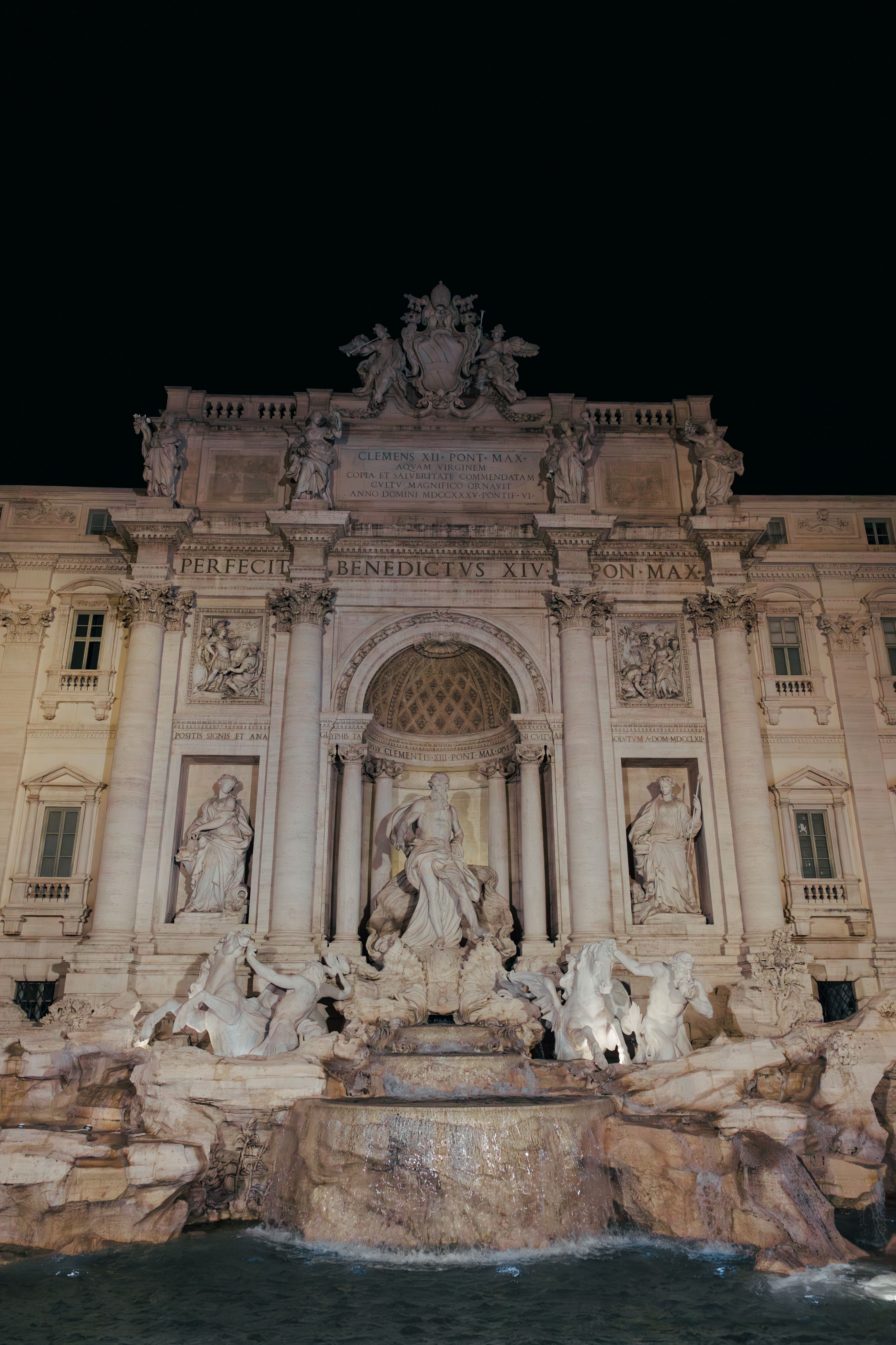 Stunning view of the illuminated Trevi Fountain in Rome, capturing its grandeur at night.