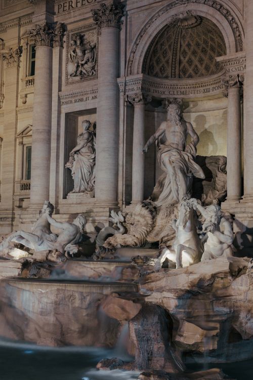 Free Beautifully lit Trevi Fountain in Rome captured at night, showcasing its stunning sculptures and architecture. Stock Photo