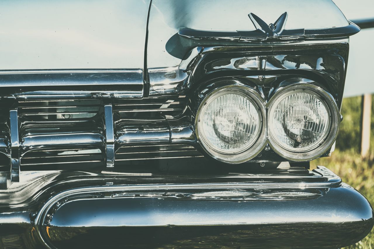 high resolution photo of vintage car headlights with chrome detailing