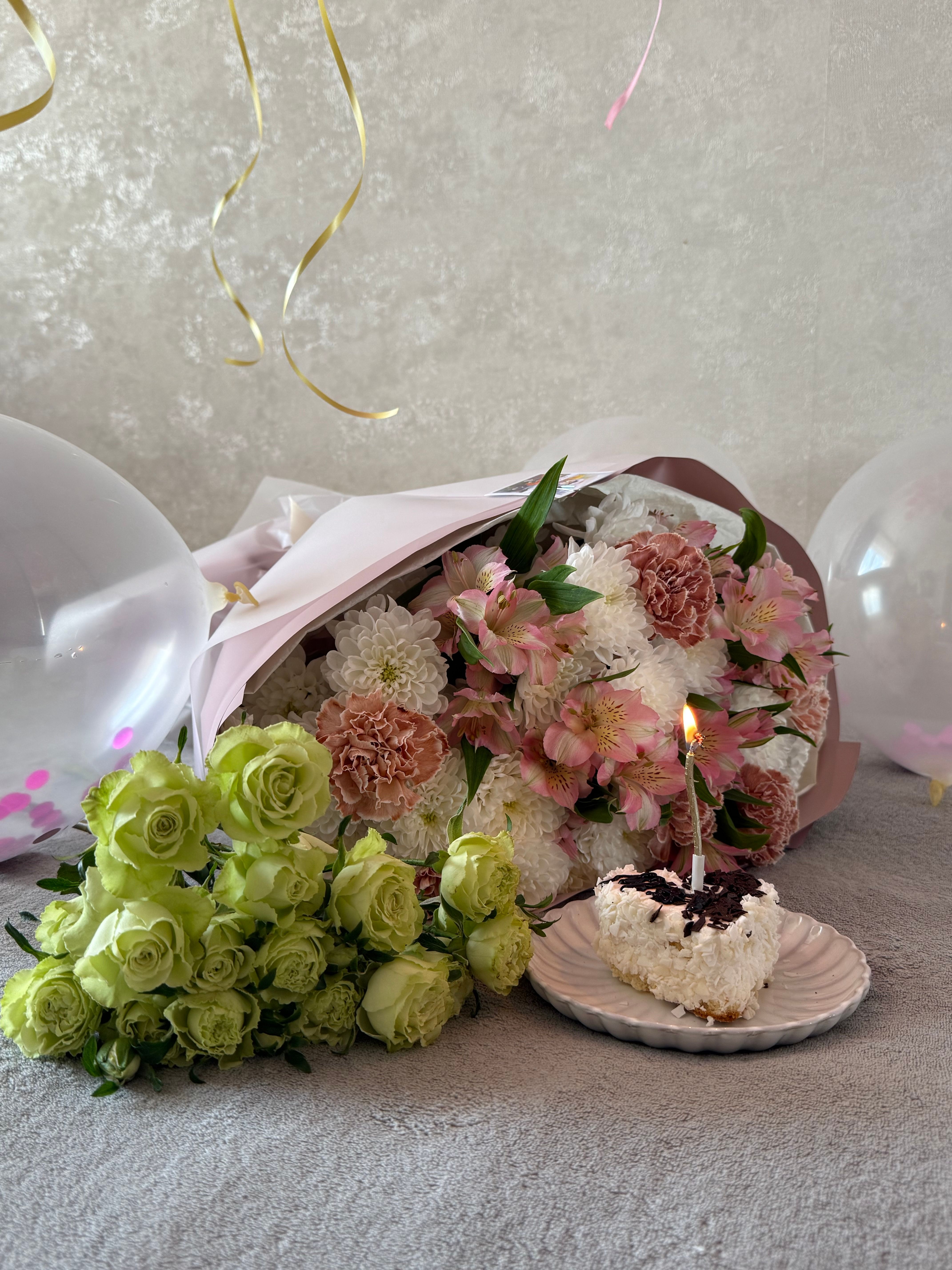 Celebration spread with cake and a bouquet
