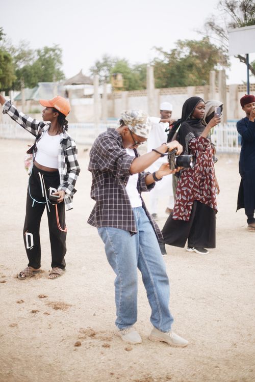 Free Group of diverse individuals taking photographs and enjoying outdoor photography activity. Stock Photo