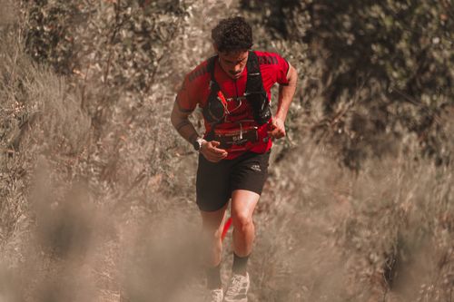 Free Athletic man trail running in a natural setting, showcasing endurance and determination. Stock Photo