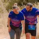 Two athletes completing a functional fitness race workout together during an outdoor endurance event.