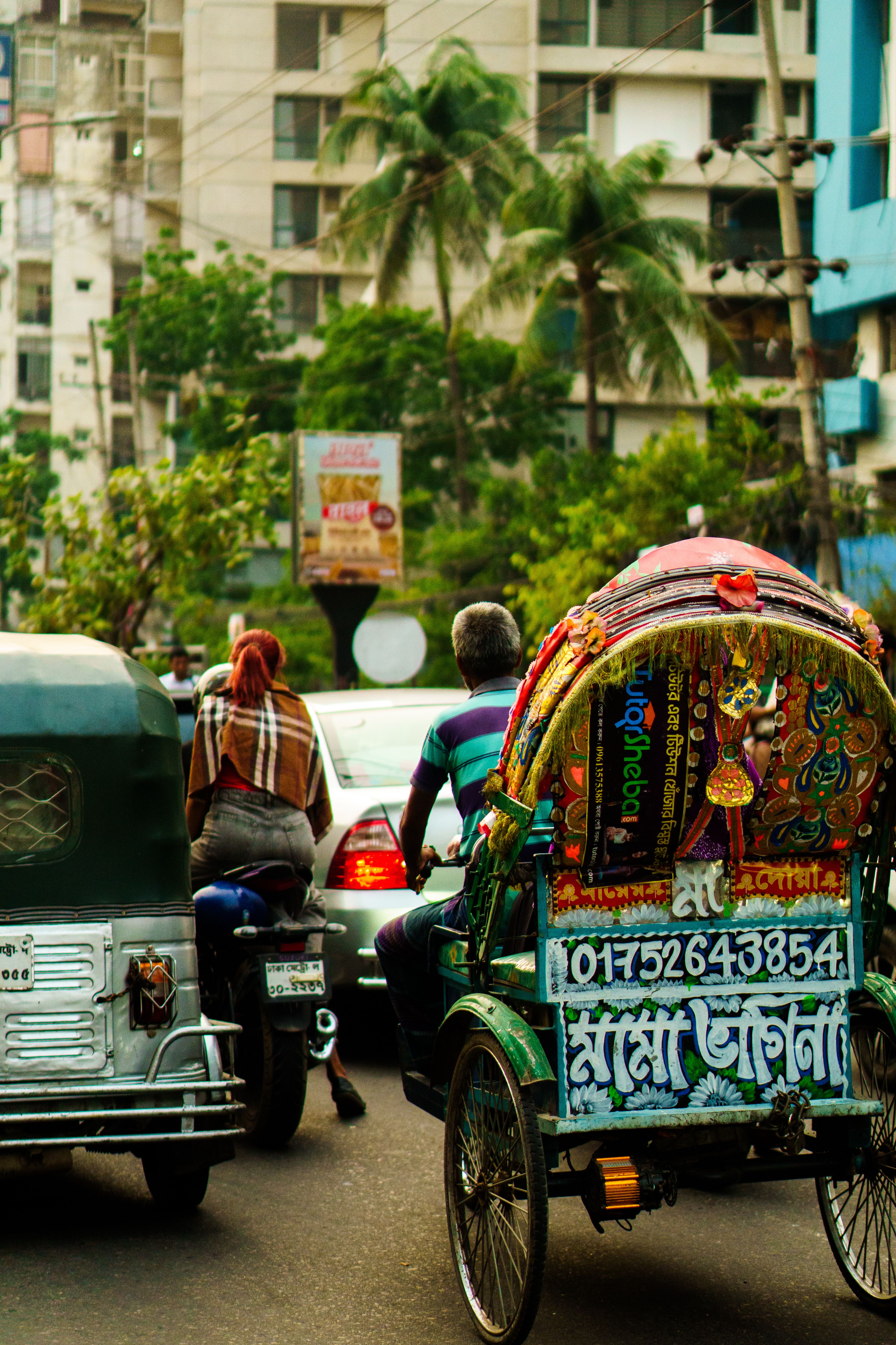 Man Driving a Rickshaw in the Middle of the Road · Free Stock Photo