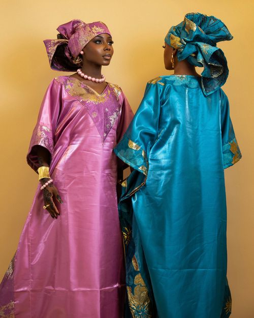 Free Two Nigerian women in vibrant traditional dresses and headwraps, showcasing cultural elegance. Stock Photo