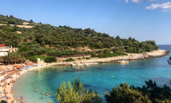 Scenic beach cove with clear turquoise waters at Vis Island, Croatia, perfect for a summer getaway.