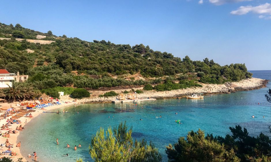 Scenic beach cove with clear turquoise waters at Vis Island, Croatia, perfect for a summer getaway.