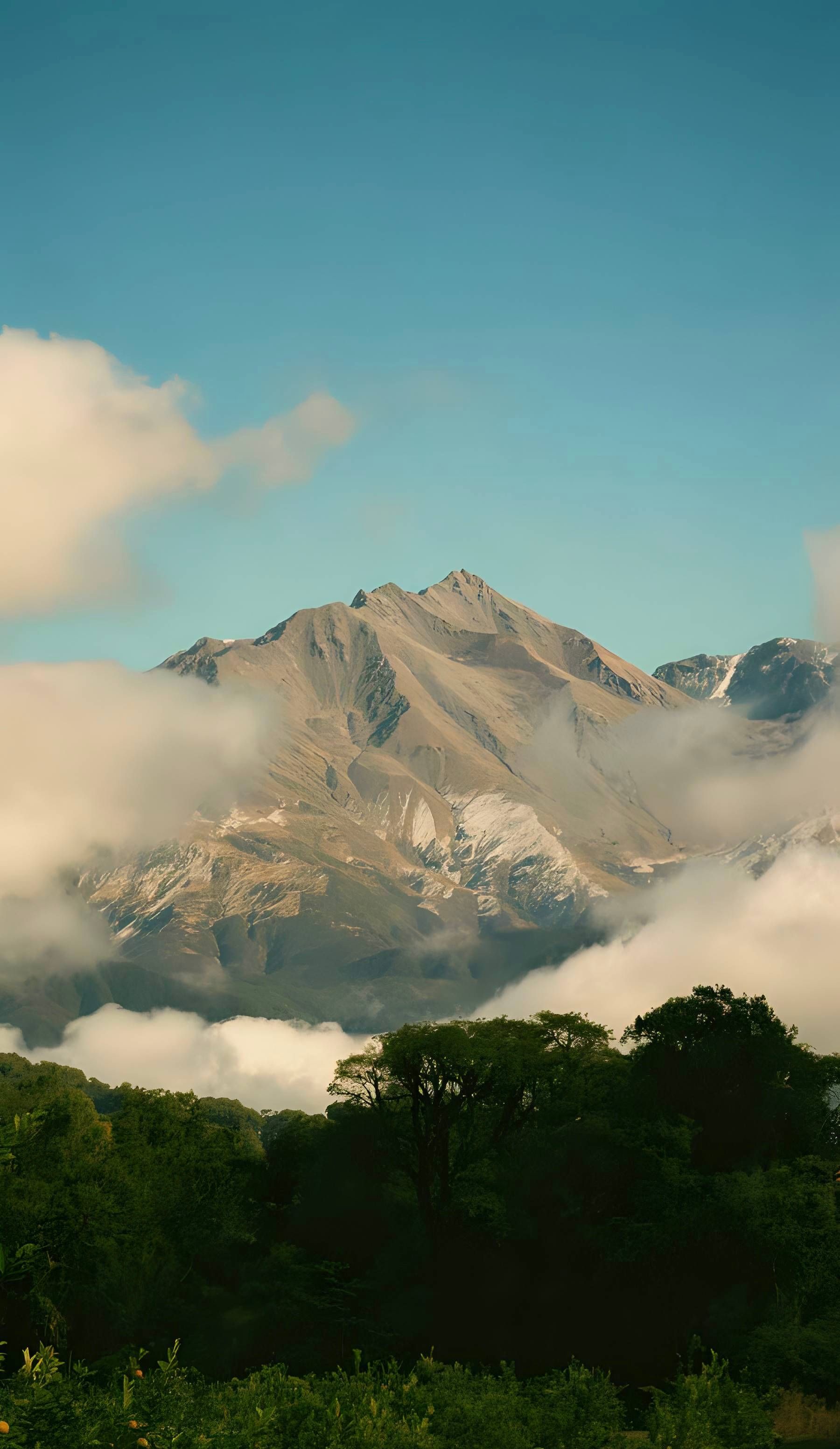 Stunning view of the Andes mountains surrounded by clouds in Alpachiri, Argentina.