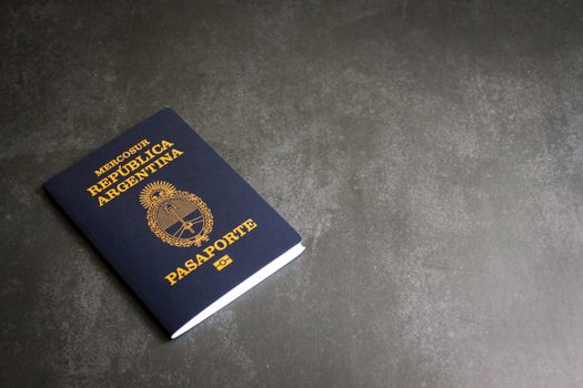 High-quality image of an Argentinian passport on a dark slate background, ideal for travel themes.