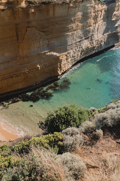 Brown Rock Formation Beside Green Sea