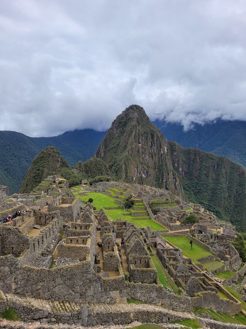 Free A breathtaking view of the ancient Incan city of Machu Picchu surrounded by mountains and clouds. Stock Photo