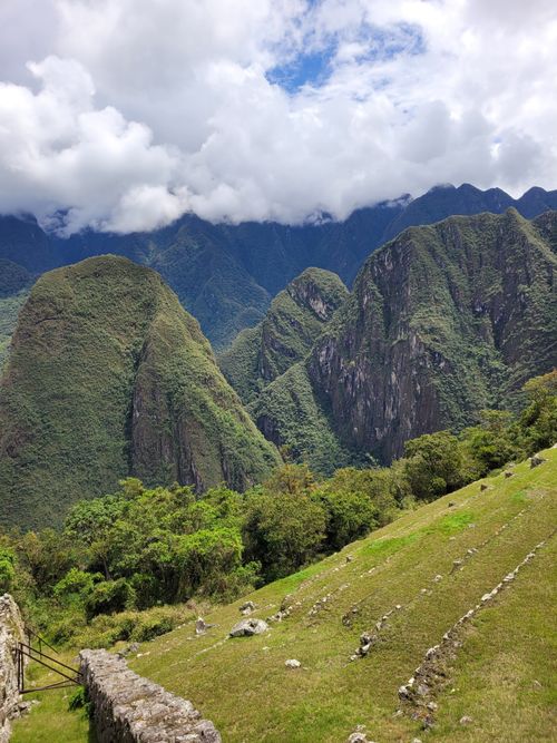 Free A stunning view of the Andes mountains with lush greenery under a partly cloudy sky in Cuzco, Peru. Stock Photo