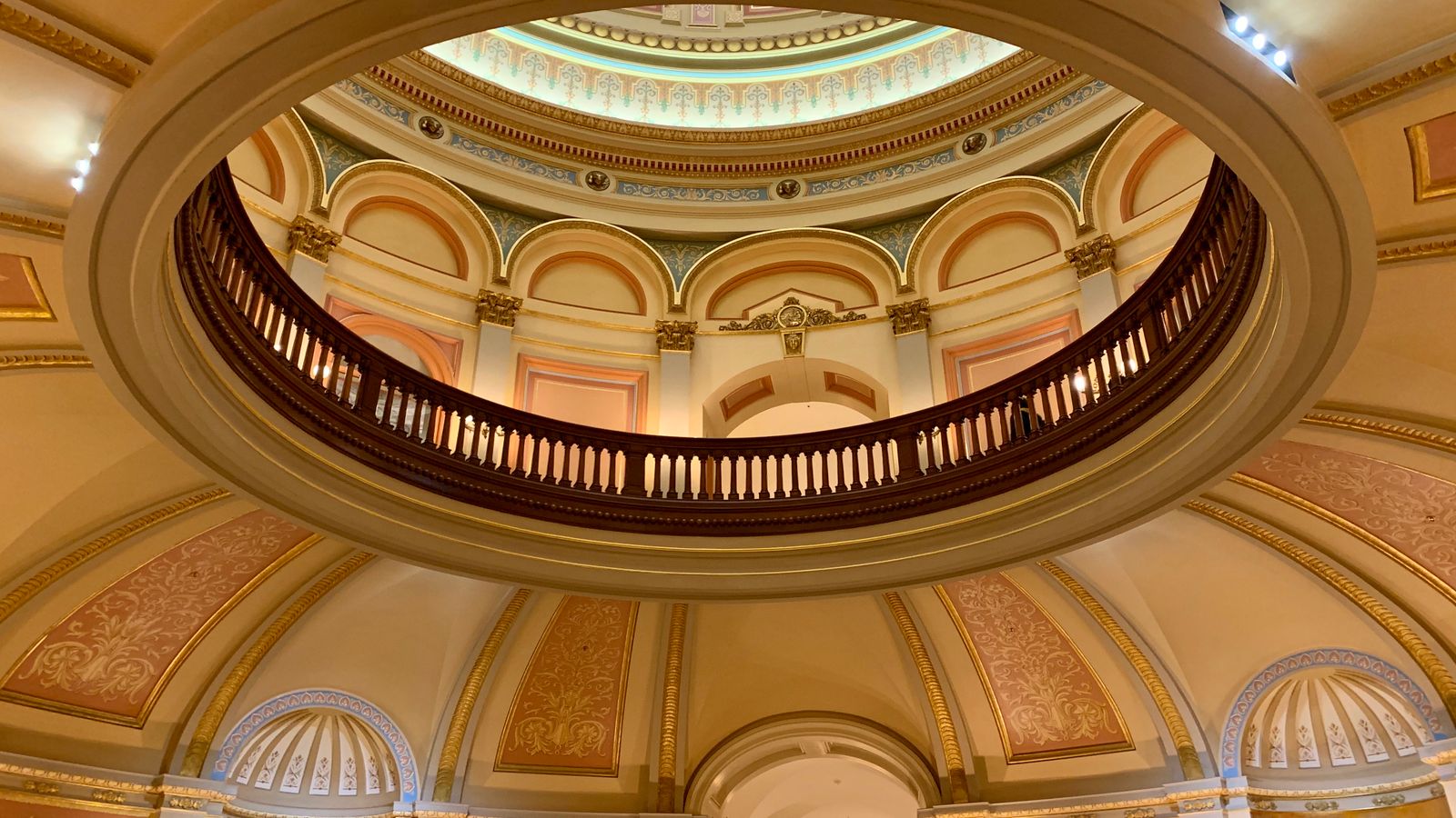 Intricate design of a dome ceiling inside Sacramento's Capitol Building, showcasing classic architectural elements.