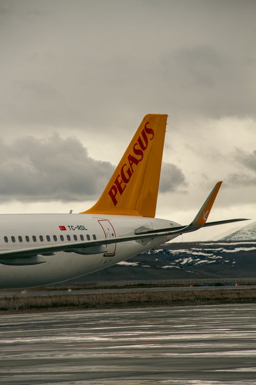Free A Pegasus Airlines aircraft on the tarmac at Kars Airport with snowy mountains in the background. Stock Photo
