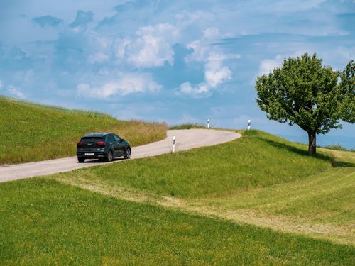 Rental car driving through the Swiss Alps or Tuscany countryside