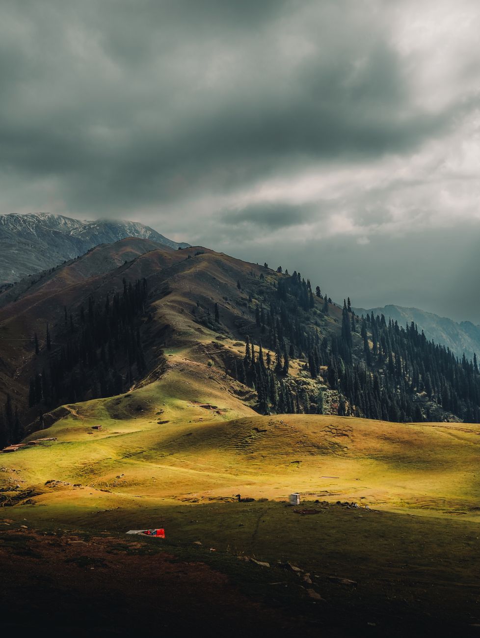 Majestic view of Naran's rolling hills under stormy skies, Khyber Pakhtunkhwa, Pakistan.