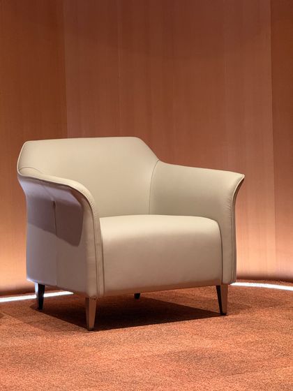 Cream armchair in a warm-toned interior — photo by Evolunshy on Pexels