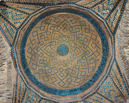 Beautifully detailed Islamic dome showcasing geometric patterns and Arabic calligraphy.