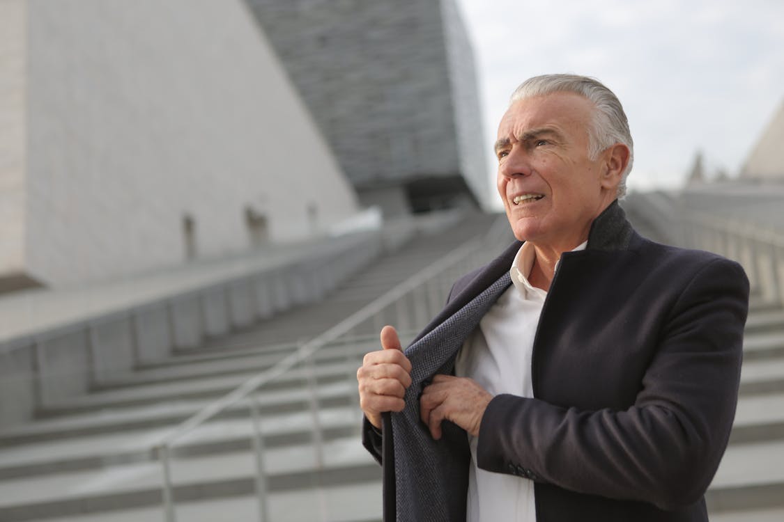 Free Determine mature gentleman on stone steps in city Stock Photo