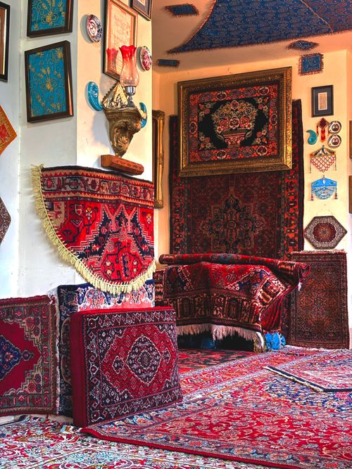 Free Explore traditional Persian carpets and decor in a vibrant interior from Kermanshah, Iran. Stock Photo