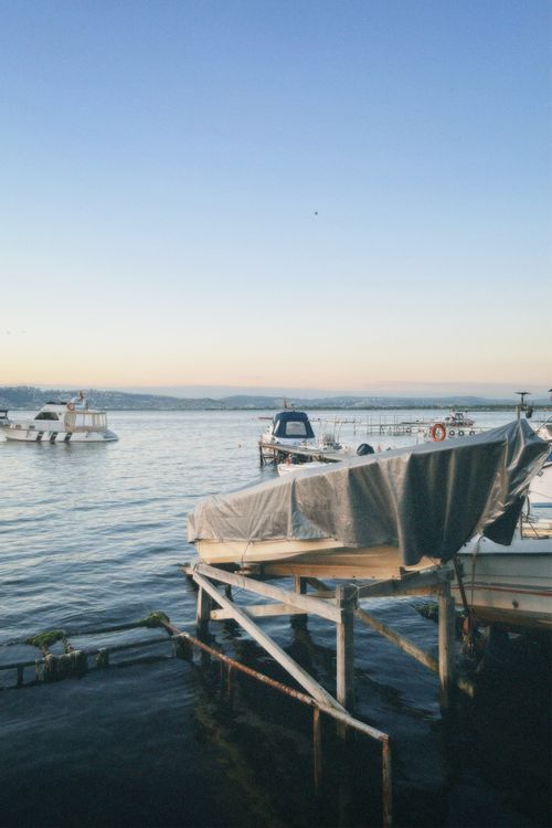Free Serene view of Yalova marina during sunset with boats gently docked by the calm waters. Stock Photo
