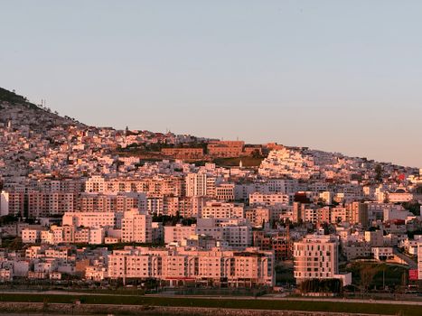 Vibrant sunset over Tangier showcasing residential architecture and the vivid hues of the city's landscape.