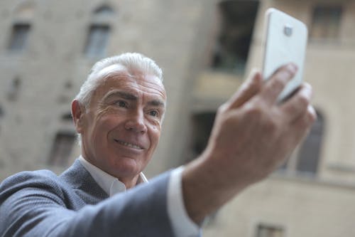Free Man Taking Selfie Using Smartphone Stock Photo
