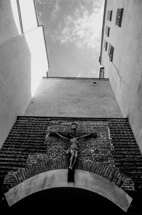 Free A striking black and white image of a crucifix on a brick wall in a Lviv courtyard, Ukraine. Stock Photo