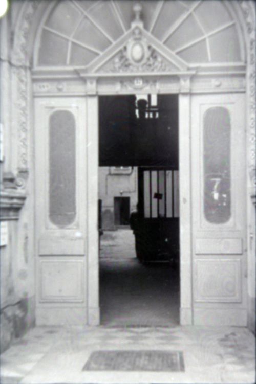 Free Black and white photo of a historic wooden doorway with an ornate arch in a classic architectural setting. Stock Photo