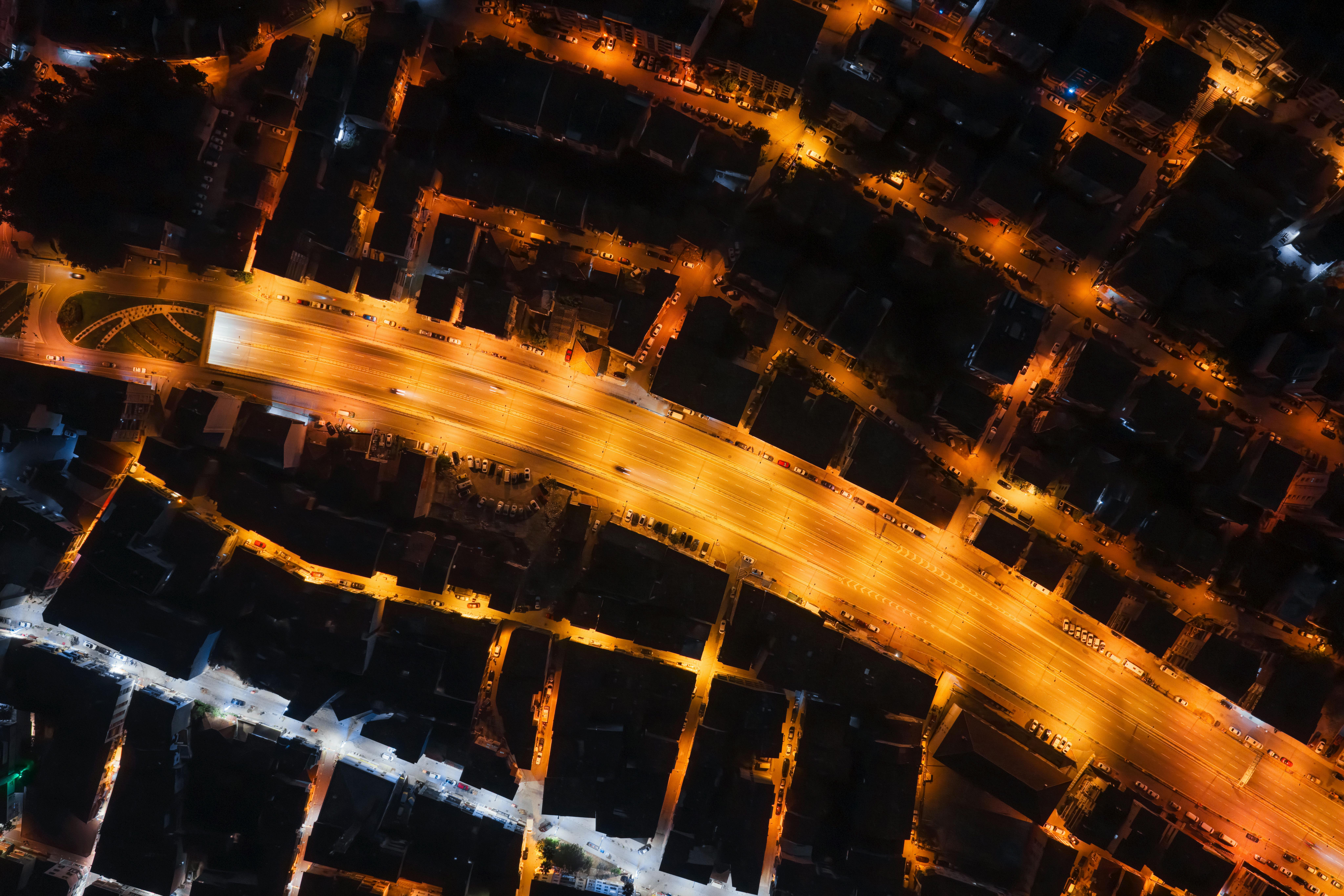 A mesmerizing aerial shot of a city with illuminated streets creating a geometric pattern at night.